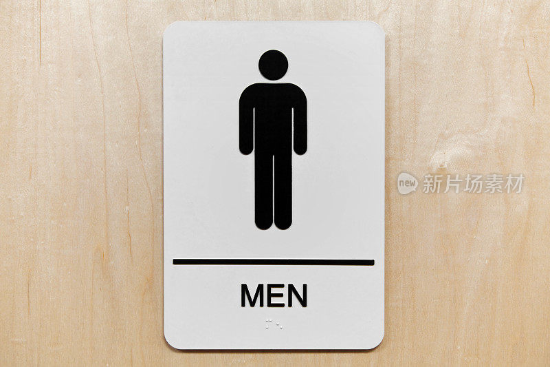 Men's restroom sign with black silhouette on light wood door